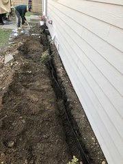 HDPE foundation waterproofing membrane installed a few inches off the foundation wall