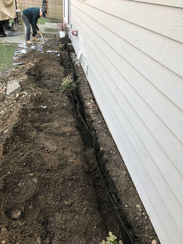 HDPE foundation waterproofing membrane installed a few inches off the foundation wall