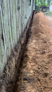 Trench dug for tree root barrier