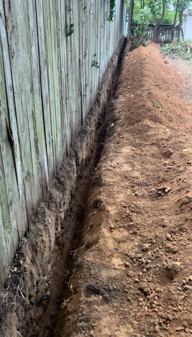 Trench dug for tree root barrier