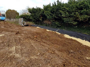 HDPE barrier sheeting installed edge-on in a trench along a hedge line to block root spread
